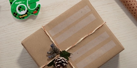 Creating gift labels using Scotch® Magic™ Tape on a wrapped gift
