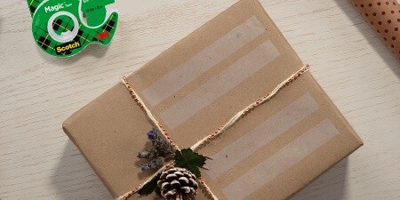 Creating gift labels using Scotch® Magic™ Tape on a wrapped gift
