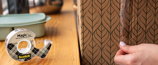 Scotch® Magic™ Tape made with 66% plant-based adhesive in use, for fixing a box

