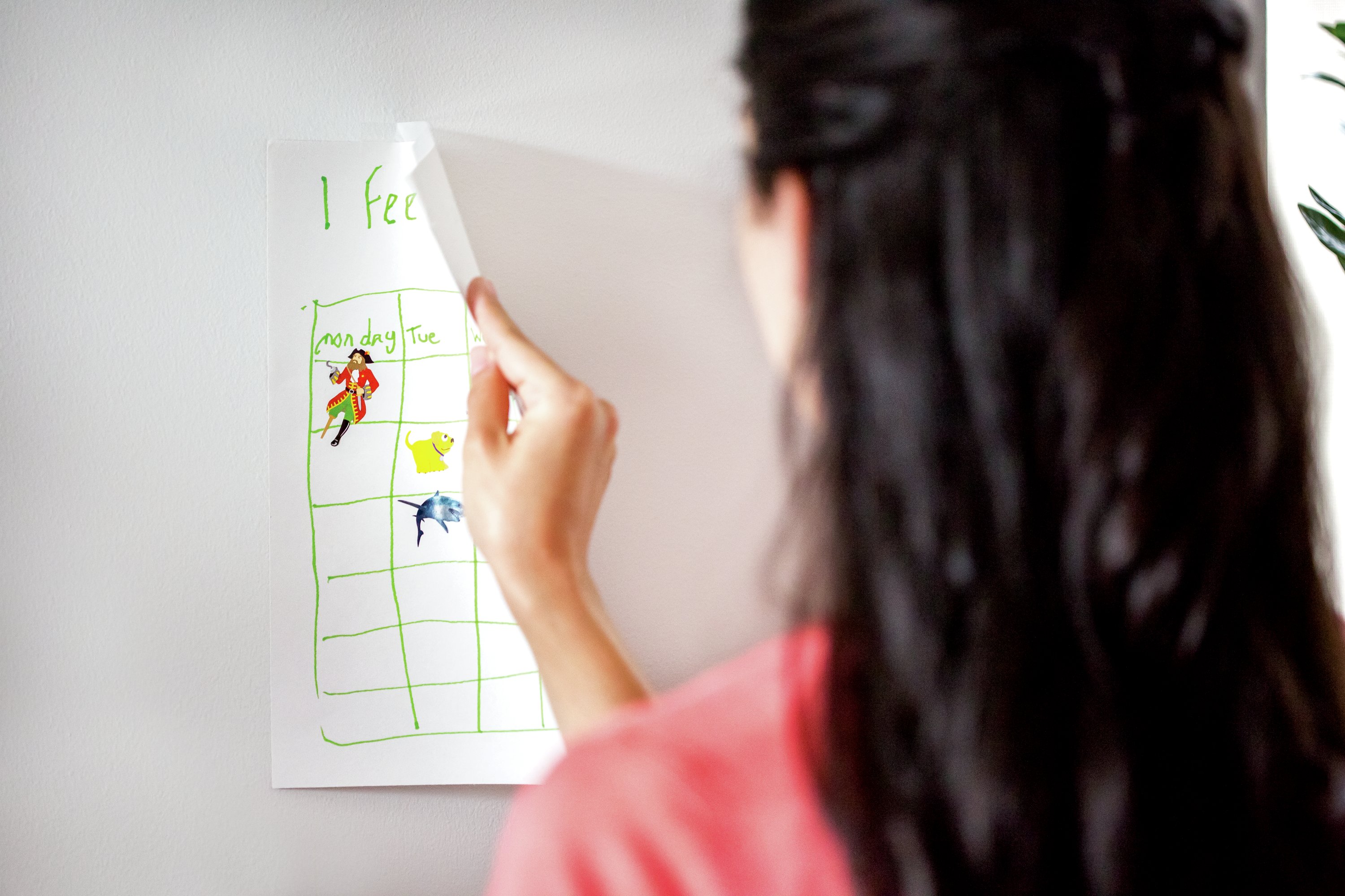 Lady removing poster from wall