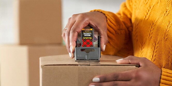 Woman using Scotch Box Lock Shipping Tape
