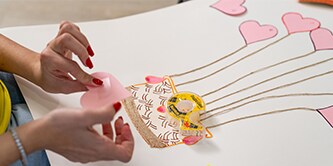 Girl creating artwork with Scotch® Double-sided Tape
