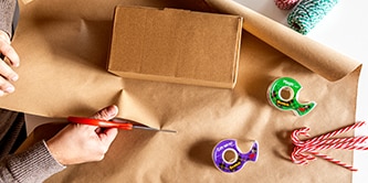 Creating a minimalist look for a gift wrap with plain packaging paper and candy canes
