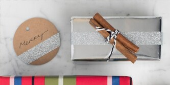 Spiced up Christmas wrapping created using a cinnamon stick attached on top of a present
