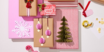 Christmas decorations and paper crafts like trees and baubles attached to wrapped gifts using Scotch® Double-Sided Tape
