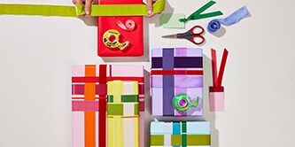 Colourfully wrapped gifts lying on a desk
