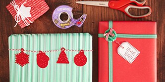Creating a traditional Christmas gift wrap look with red, green, and white colours, and attaching paper figures with Scotch® Double-Sided Tape
