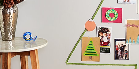 Christmas decorations attached to a wall using Scotch® Wall-Safe Tape
